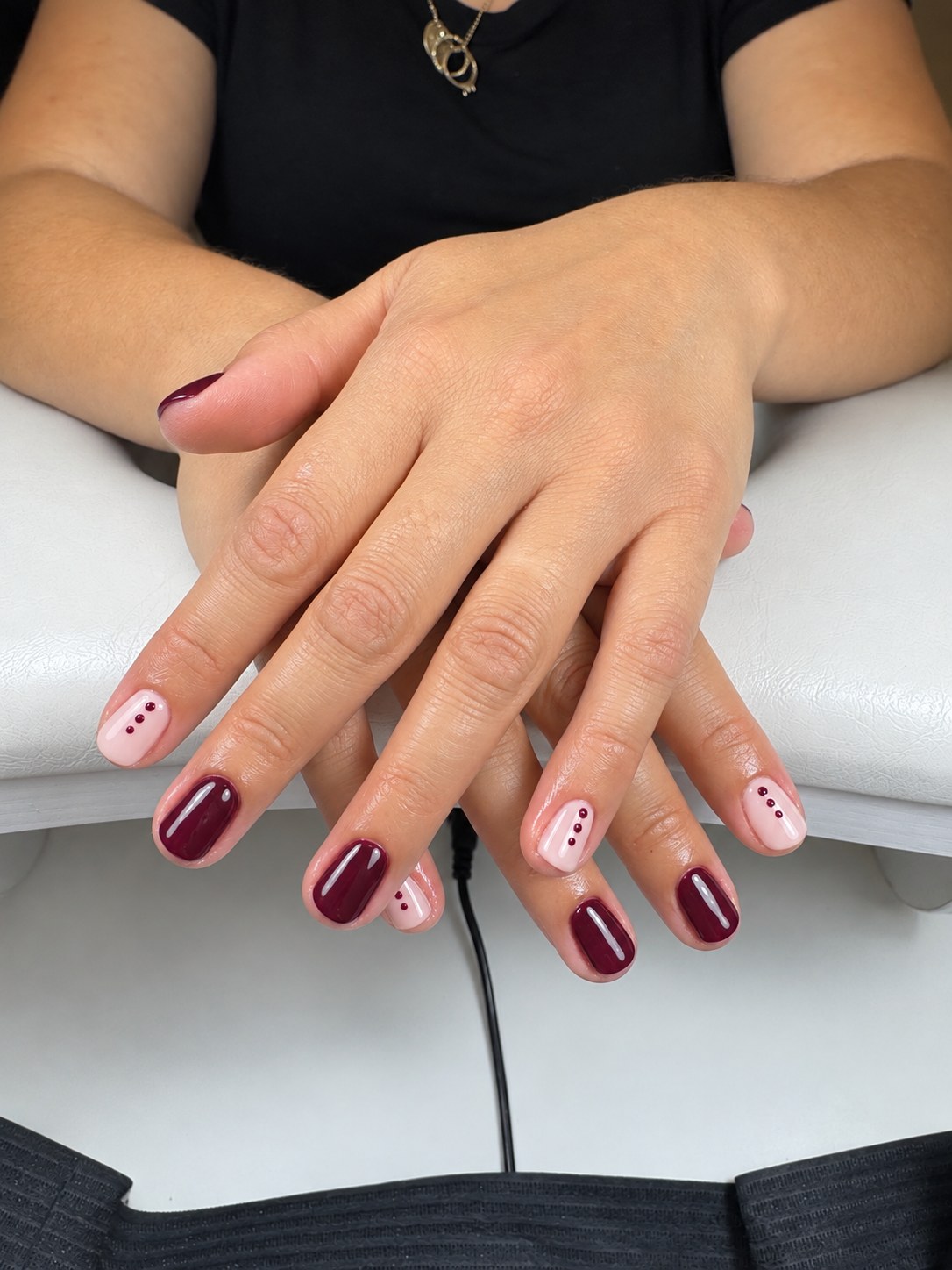 Burgundy gel manicure with blush-pink dot nail art
